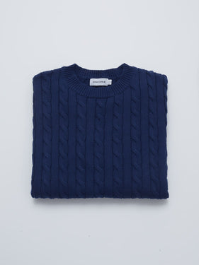 navy cable knit sweater folded
