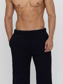 detail of men's black wide-leg sweatpants by One Dna
