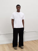 male model wears white tshirt and black sweatpants by one dna clothing