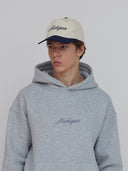 navy and white hat with michigan in cursive font