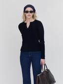 women wears black ribbed henley, black sunglasses, scarf and leather bag